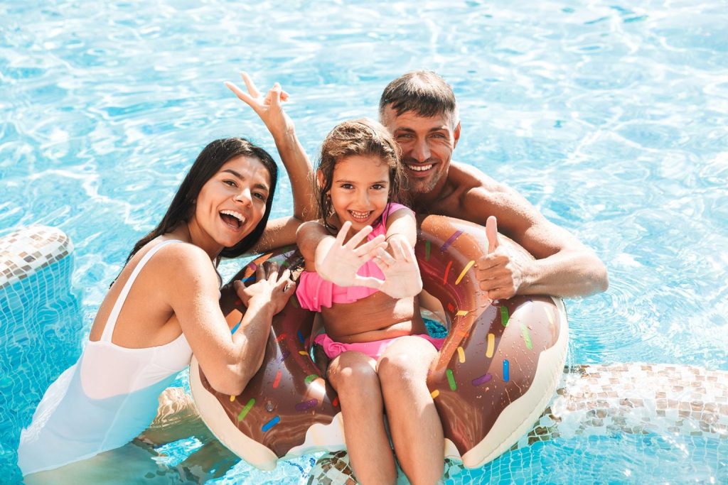 family enjoying a heated pool